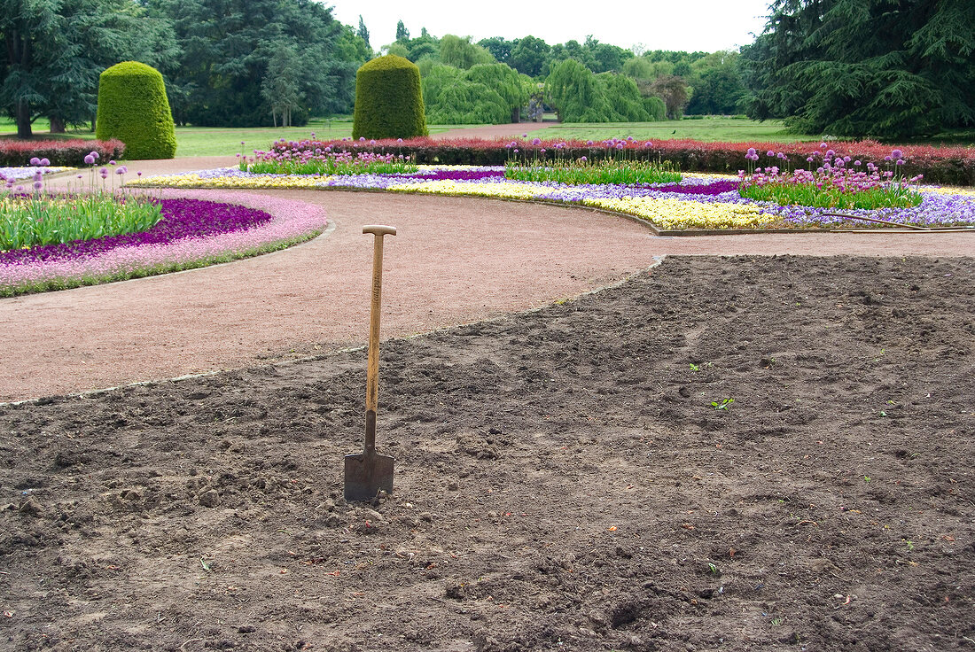 View of ploughed ground with flower beds in park