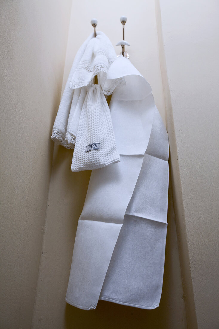 Close-up of white towel on hook in bathroom