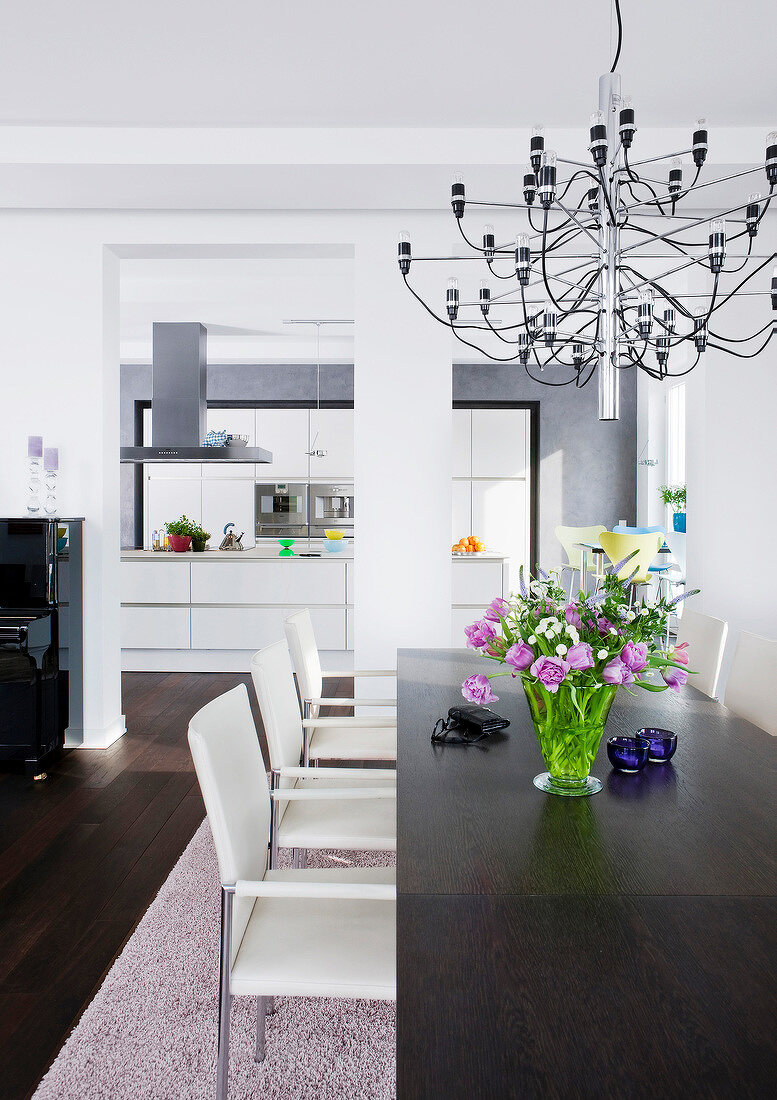 Kitchen with dining table in foreground and fitted cabinet in background