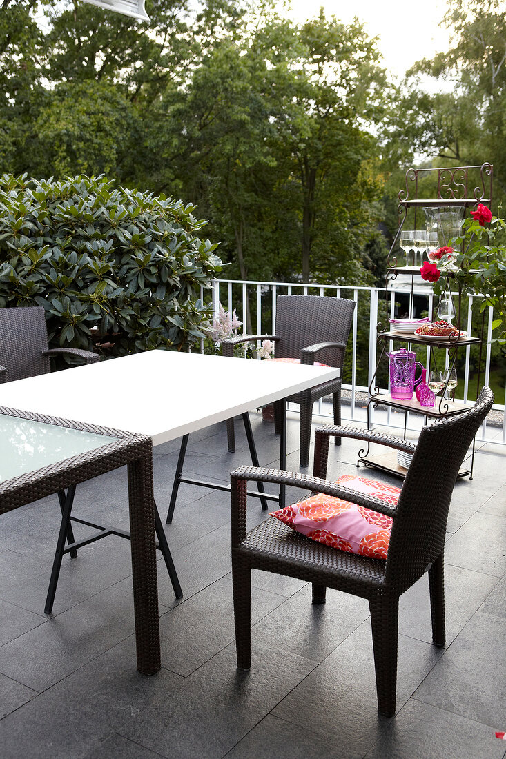 Dining table with panama armchairs in patio