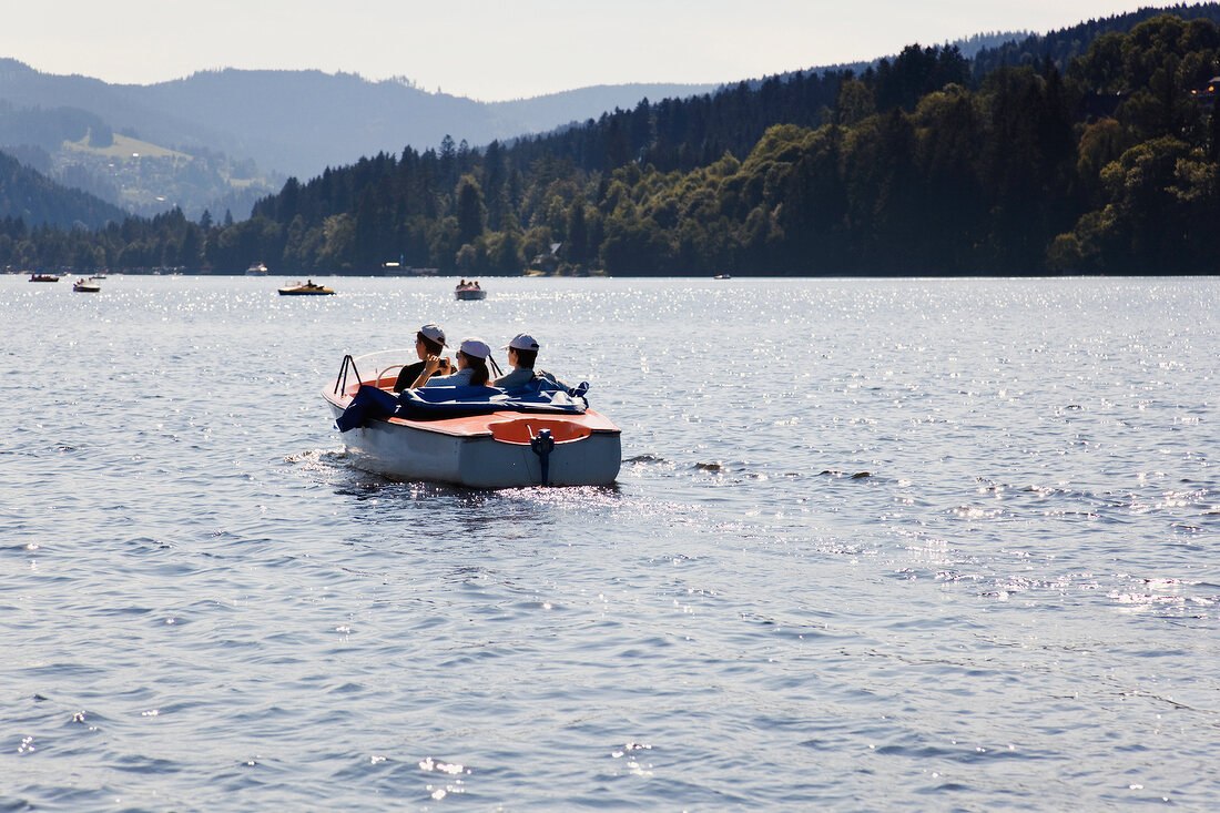 View of people on Titisee boats in lake of Black Forest, Germany