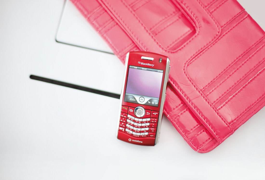 Red mobile phone with patent leather bag for magnetic closure