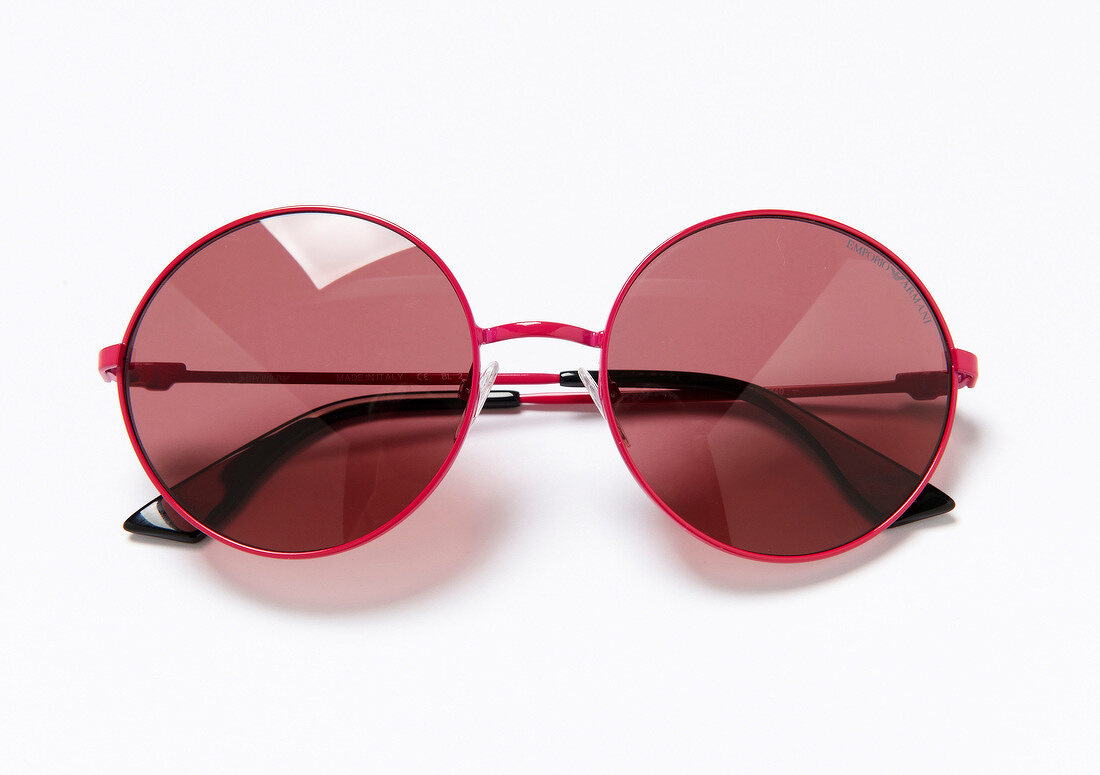 Close-up of red sunglasses on white background