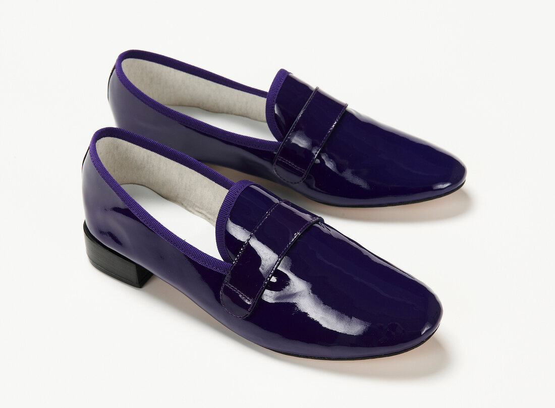 Close-up of patent leather loafers on white background