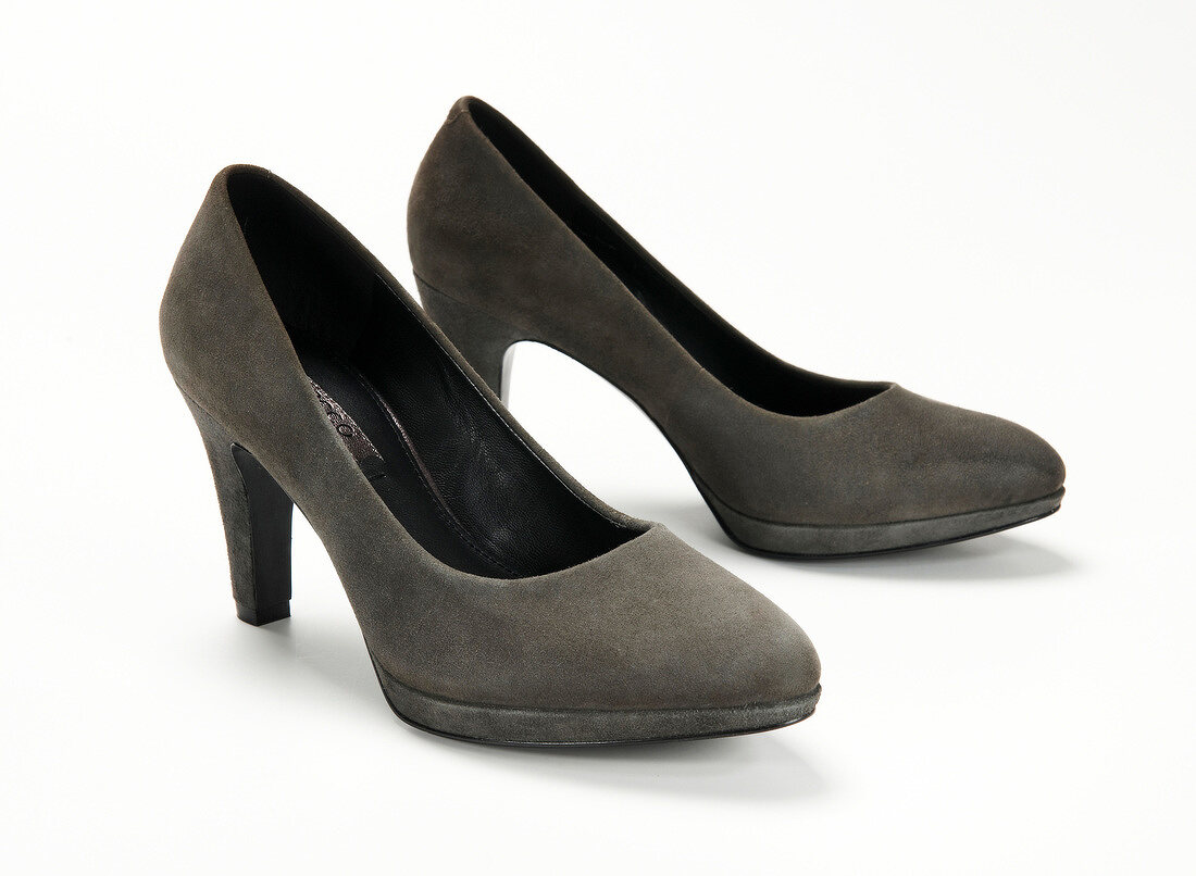Close-up of gray suede pumps on white background