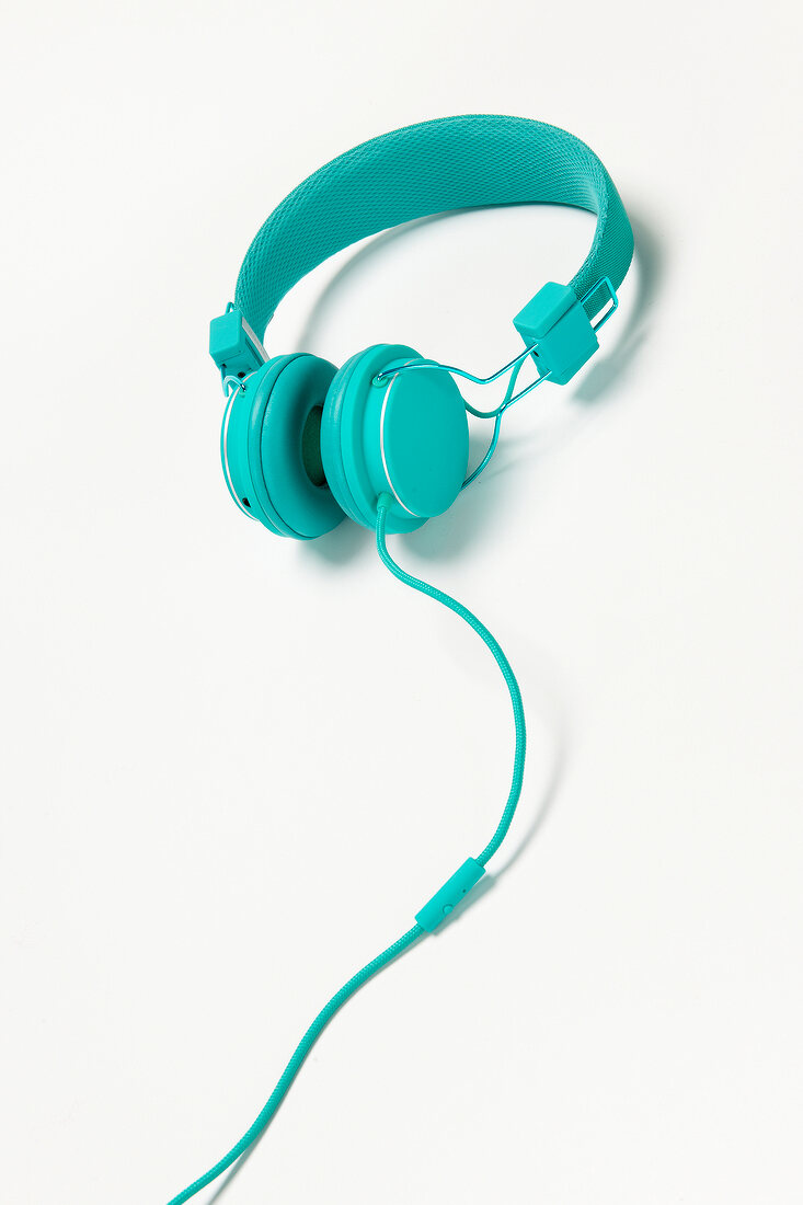Turquoise headphones on white background