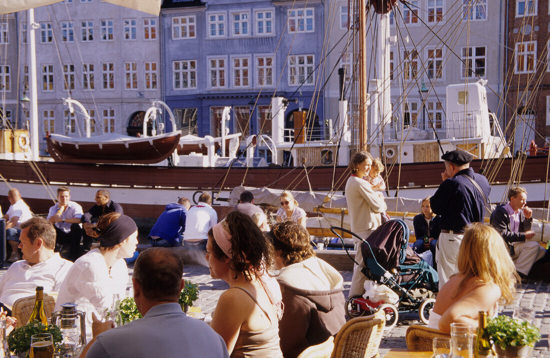 View of bars and restaurants in Nyhavn harbour in Copenhagen, Denmark
