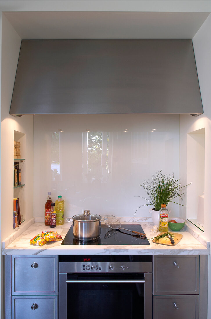 Extractor hood over cooker in modern kitchen