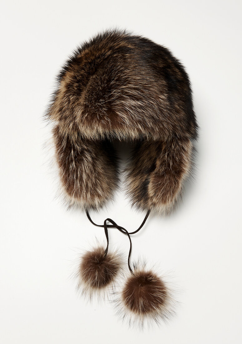 Russian fur hat in vintage style with pompons on white background