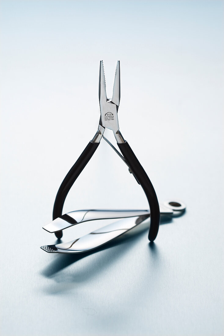 Pliers and tweezers for pulling bones on white background