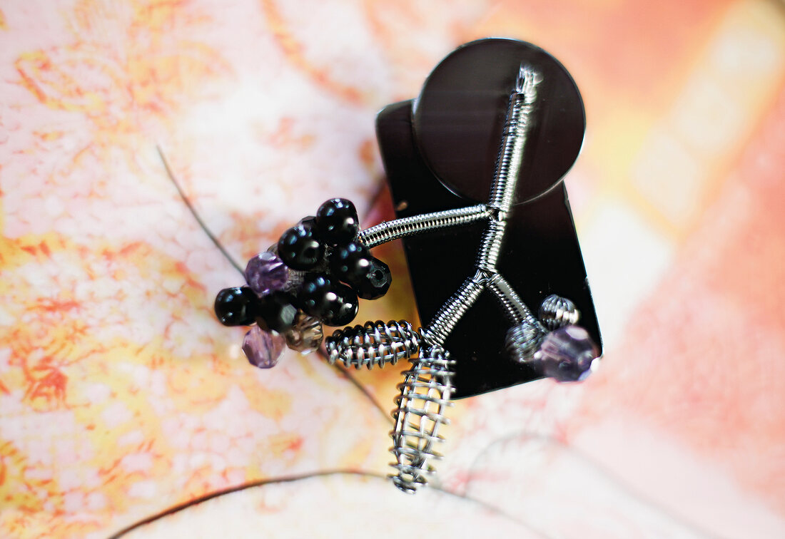 Close-up of black and purple brooch