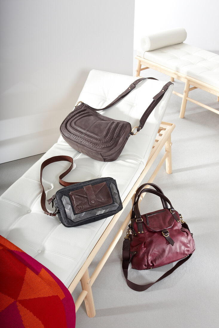 Various handbags on couch