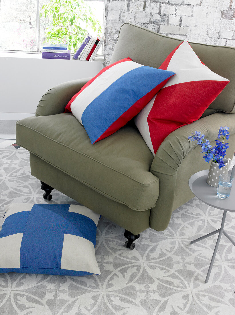 Armchair and colourful pillow with graphic patterns floor