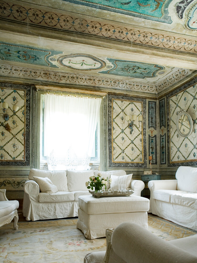 Painted ceiling and white sofa in Italian Palazzo