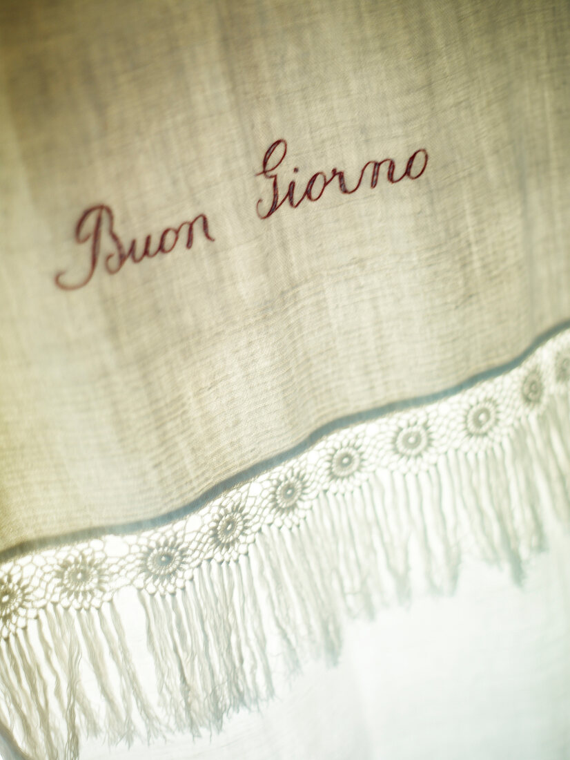 Close-up of embroidered linen in Hotel Cavoleto, Tuscany, Italy