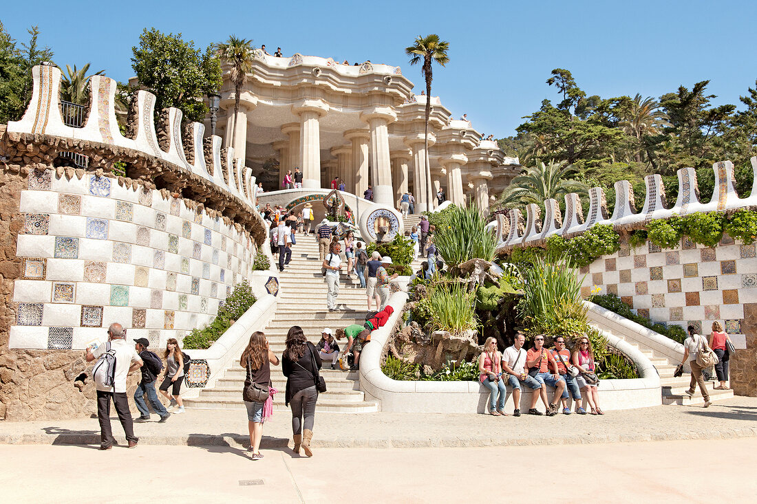 Tourists sitting at entrance of Park Guell, Barcelona, Spain