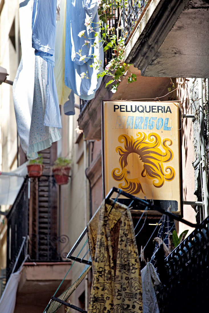 Signboard of salon in alley, Barcelona, Spain
