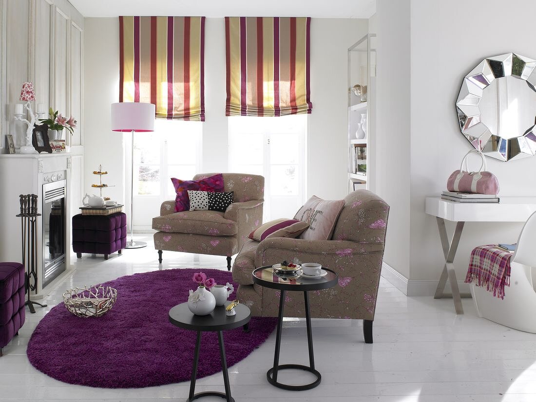 Living room with two armchair, table, fireplace and floral upholstery