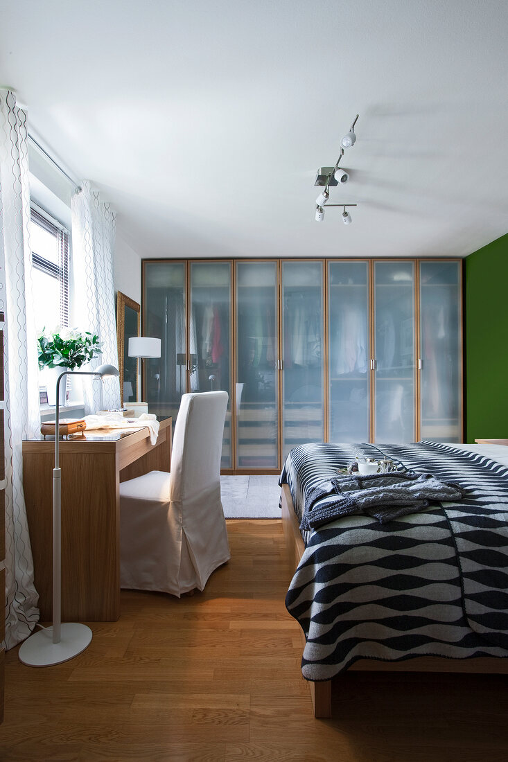 Bedroom with bed, sideboard, wardrobe and glass frosted door