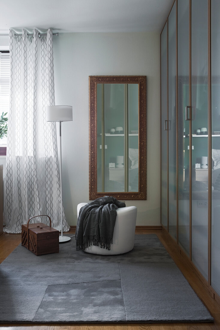 Bedroom with gilt-framed mirror wall cabinet and frosted glass doors