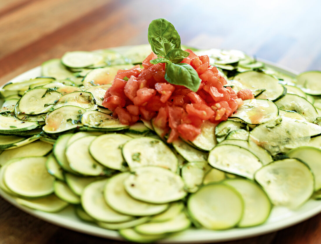 Close-up of sliced zucchinis and carpaccio on plate