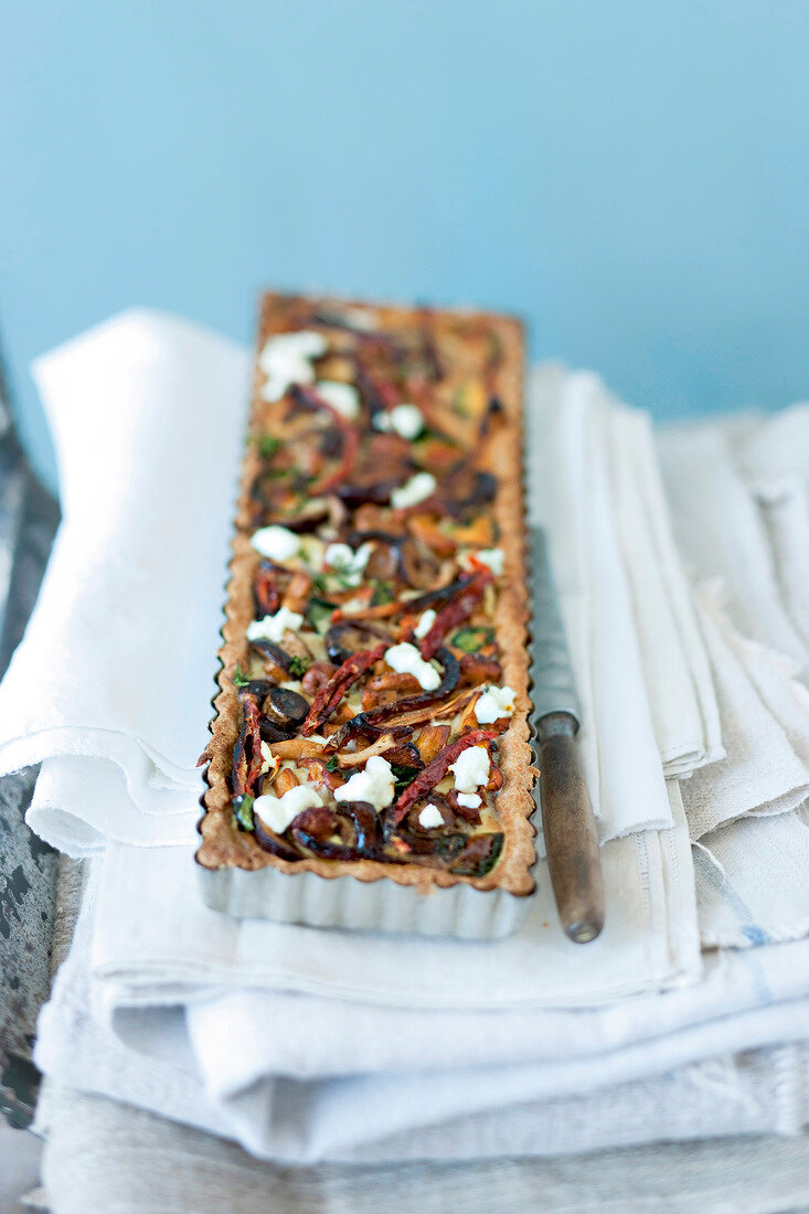 Tart with mushrooms and goat cheese, blurred