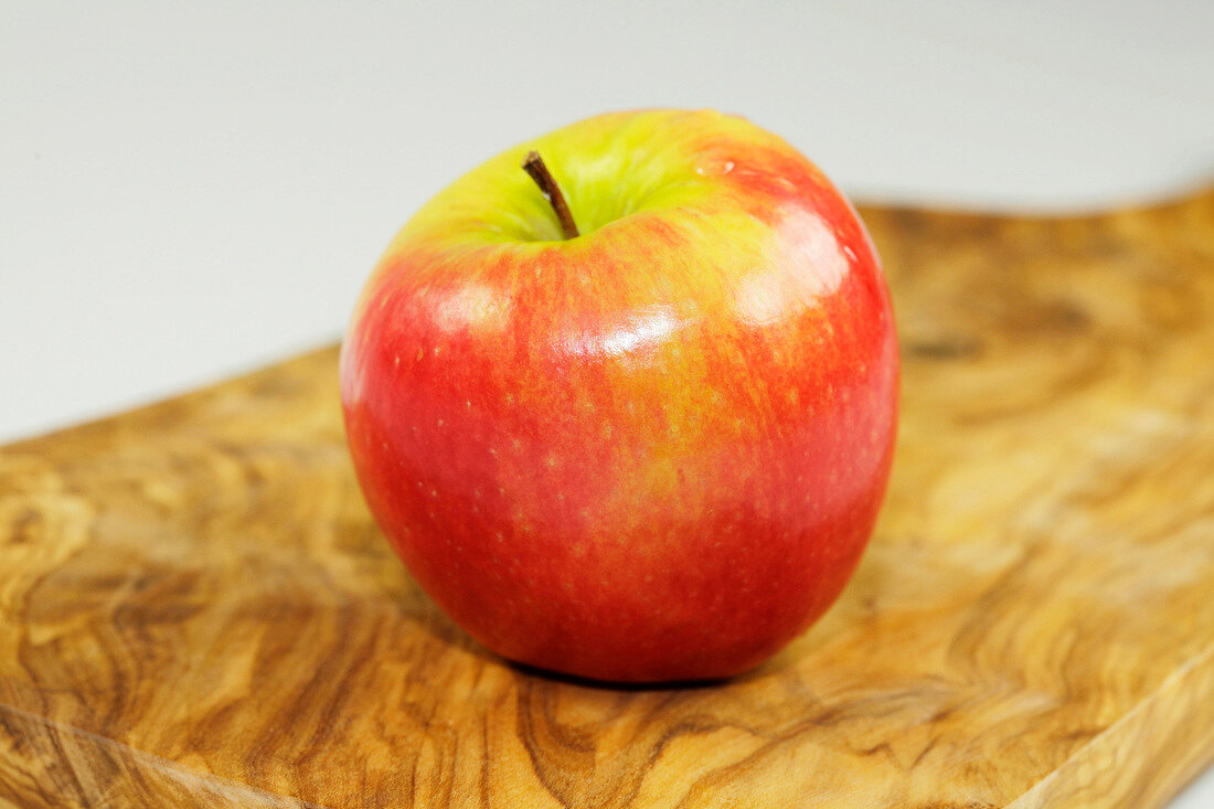 Close-up of a apple on wooden board