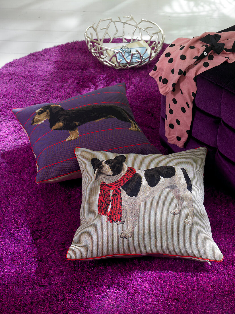 Cushions with dog motif and purple stool on purple mat