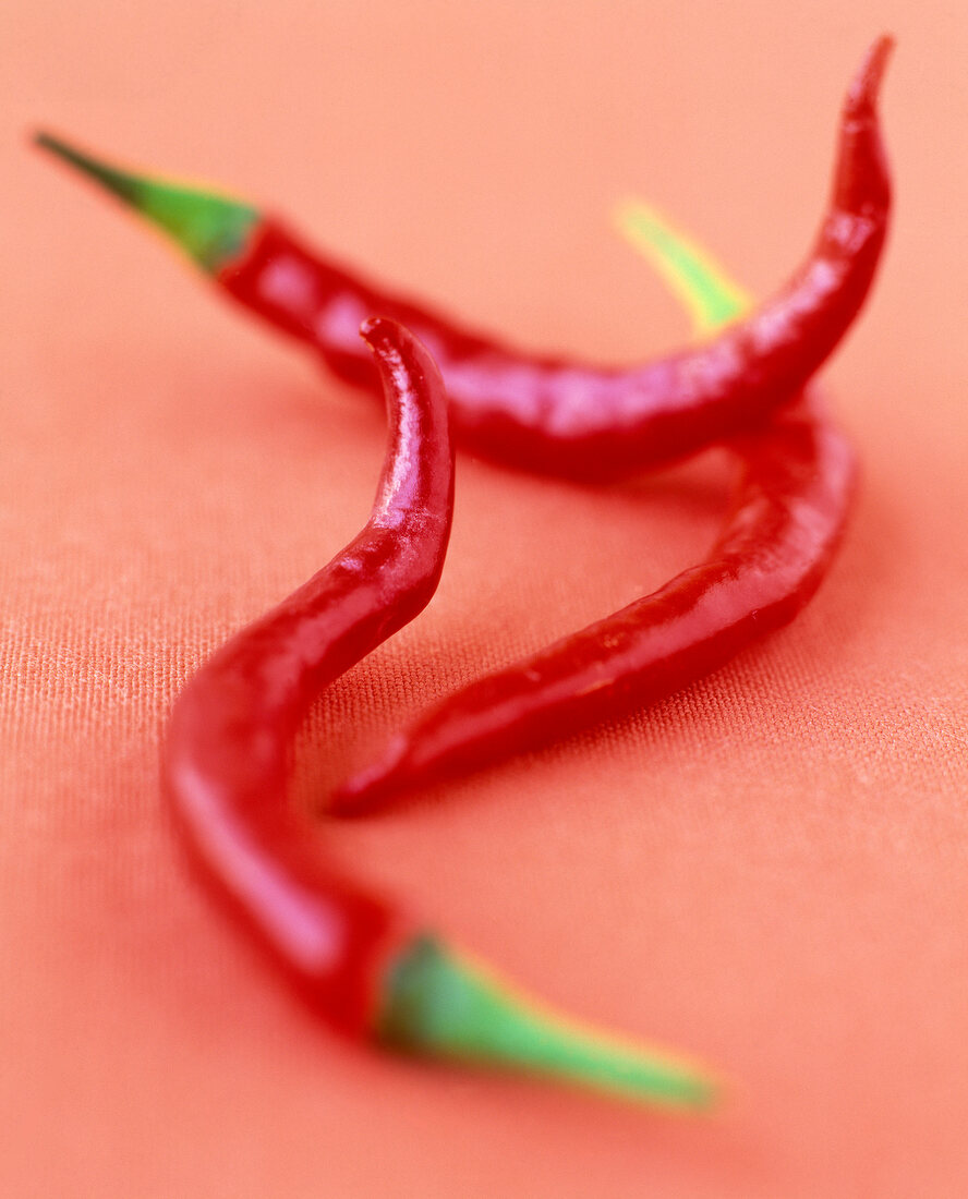 Close-up of three red chilly peppers