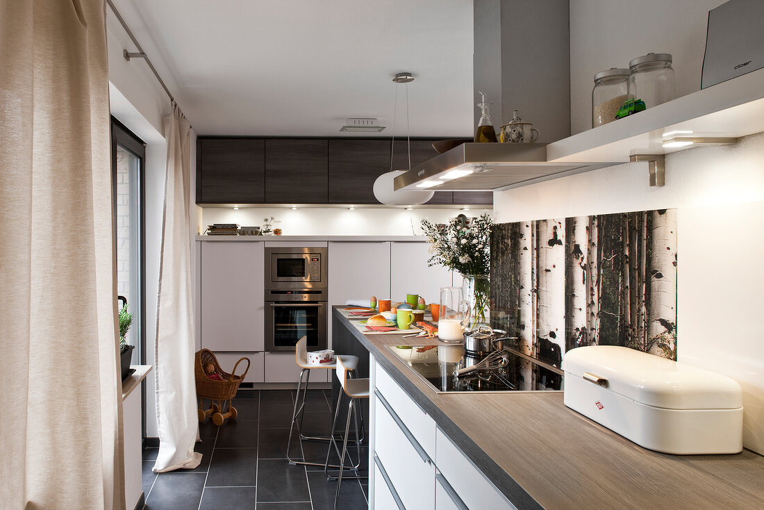 Table, chair, cabinet and shelf in modern kitchen