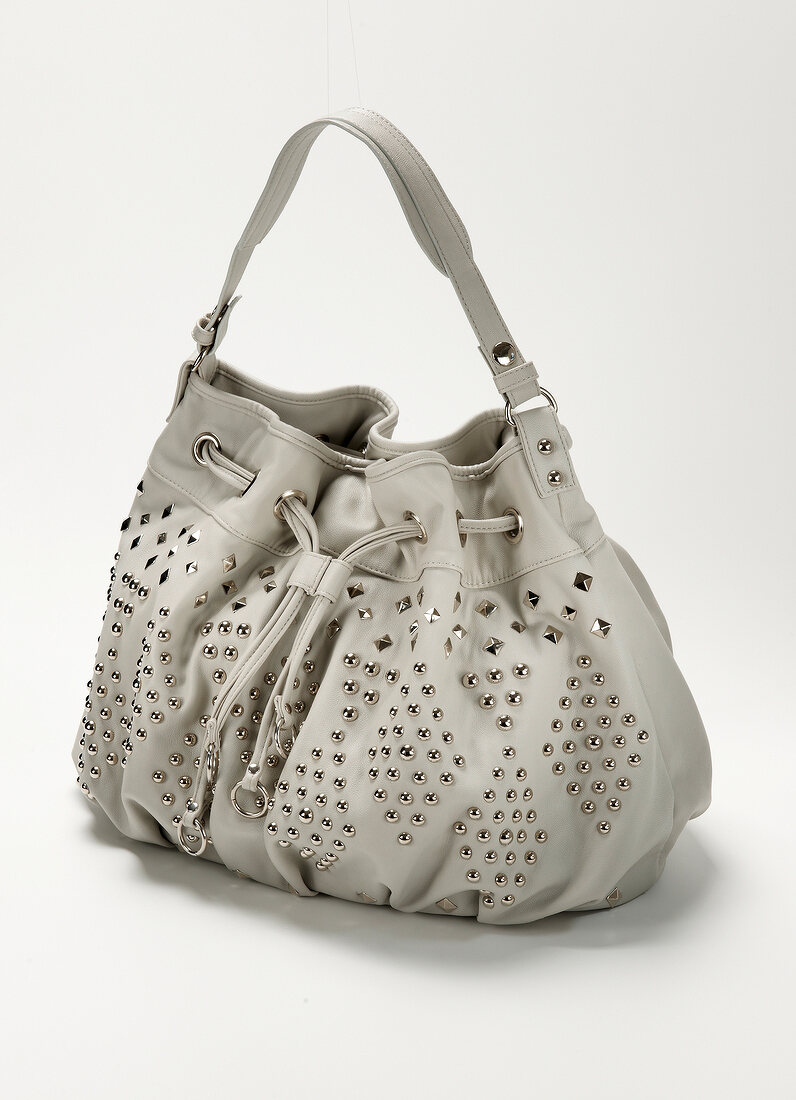 Faux leather bag with light gray rivets on white background