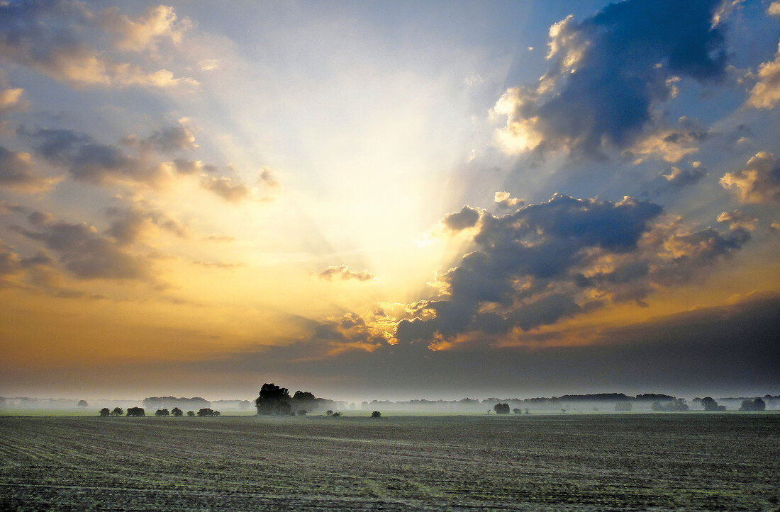 View of sunrise behind clouds in Saxony, Germany