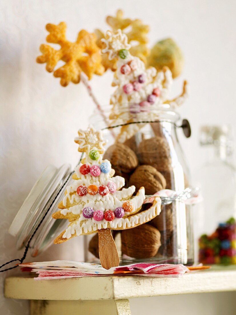 Tree and snowflake-shaped Christmas biscuits on sticks