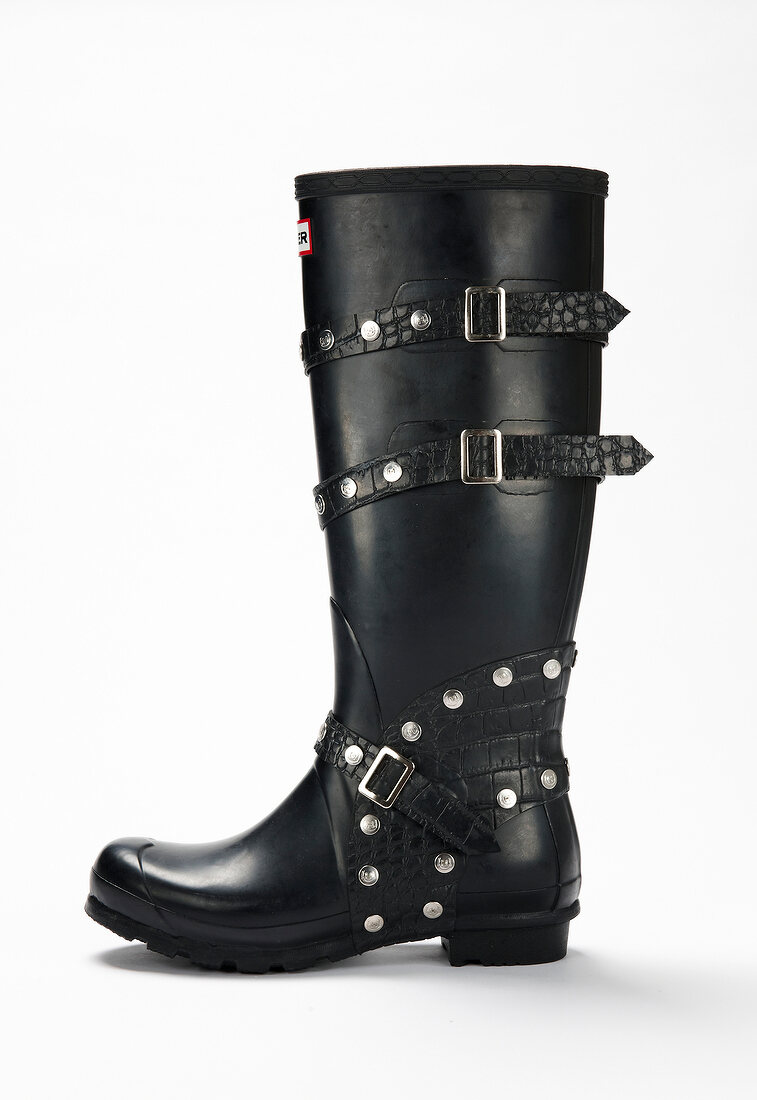 Black rubber boot with studs and buckles … – License image – 10242924 ...