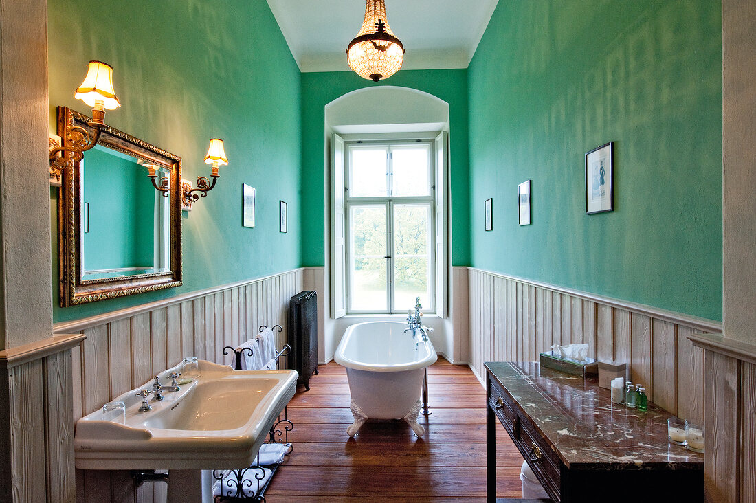 View of green wall and bathroom with bathtub at Castle Gaussig, Saxony, Germany