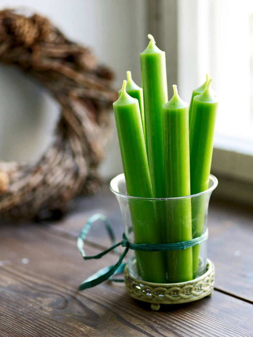 Green candles in glass