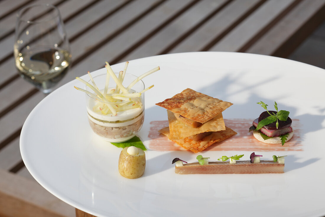 Trilogy of smoked fish on plate by Jens Rittmeye in KAI3 restaurant