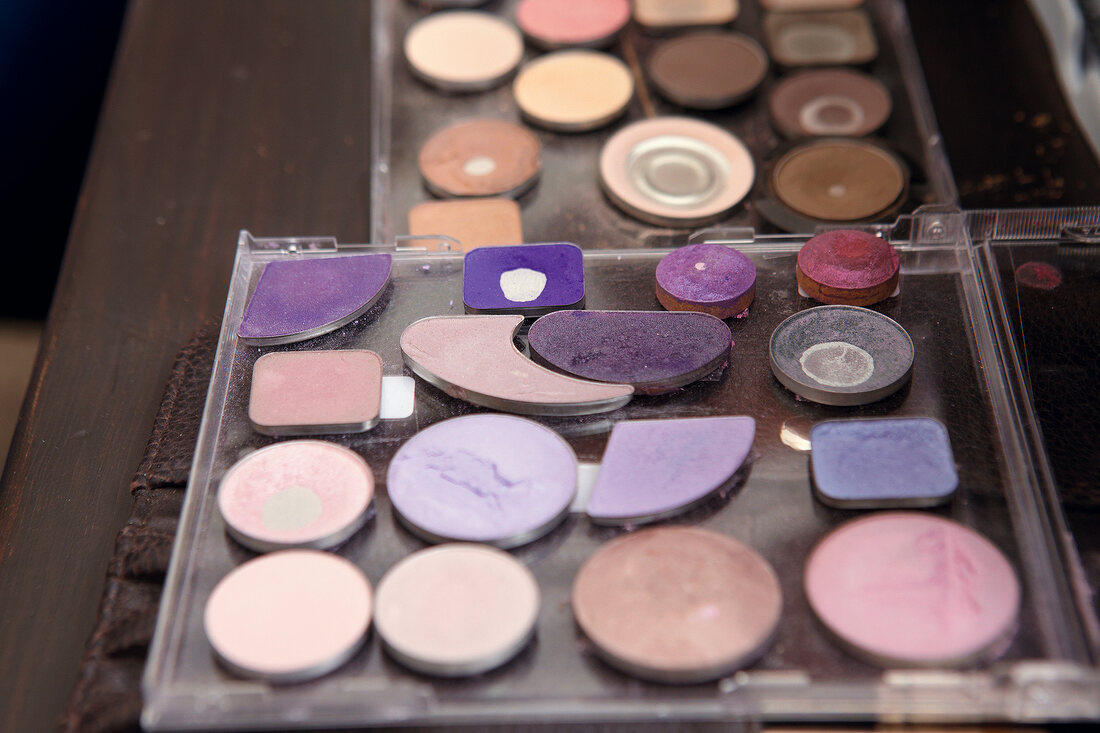 Close-up of various colours of eye shadow palettes