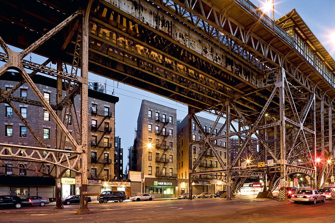 Facade of Harlem building and steel beam mill with lights at dusk, New York, USA