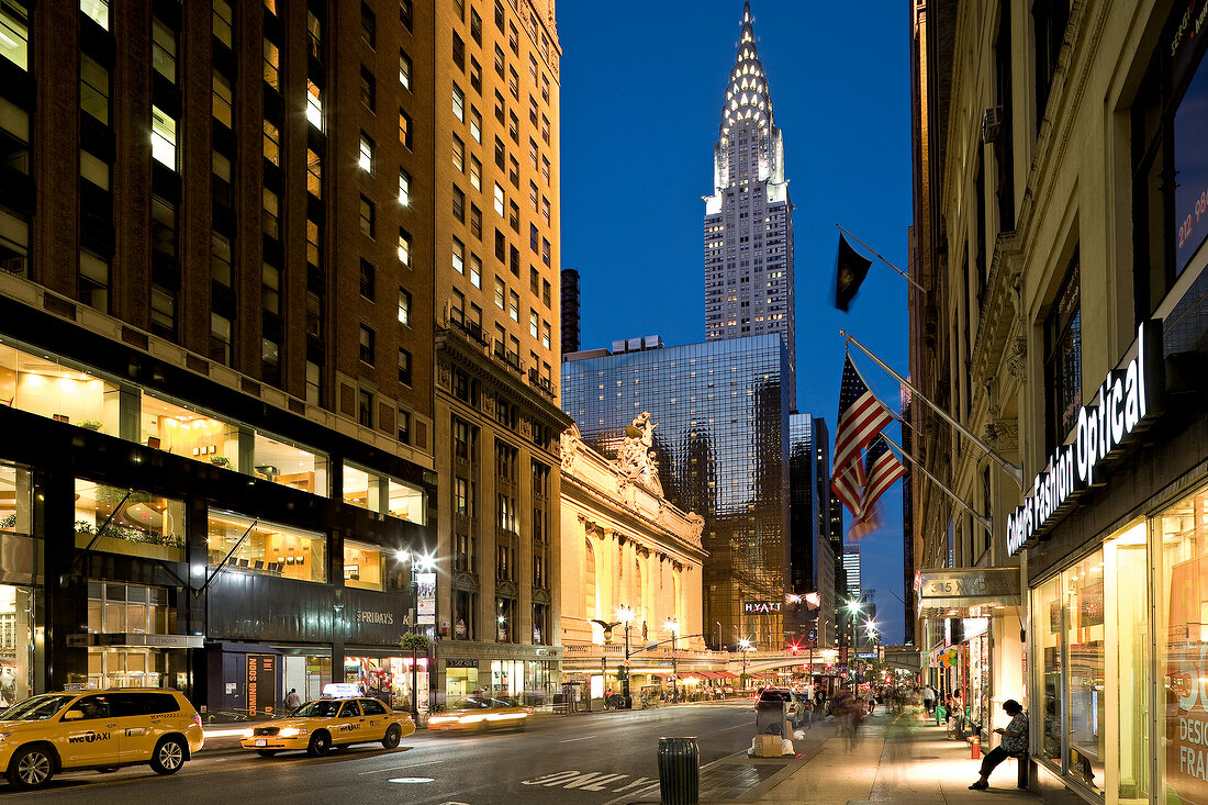 View of Chrysler building with lights and traffic on road, New York, USA
