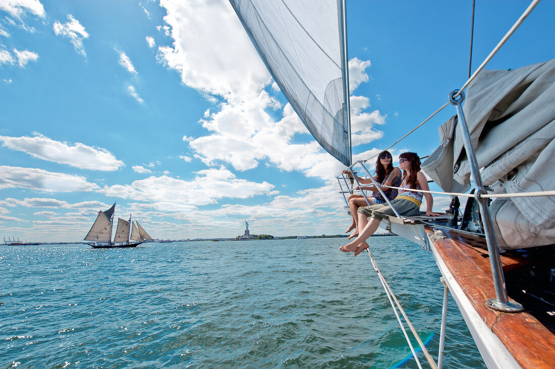 Two women enjoying on sailboat in Hudson river, New York, USA