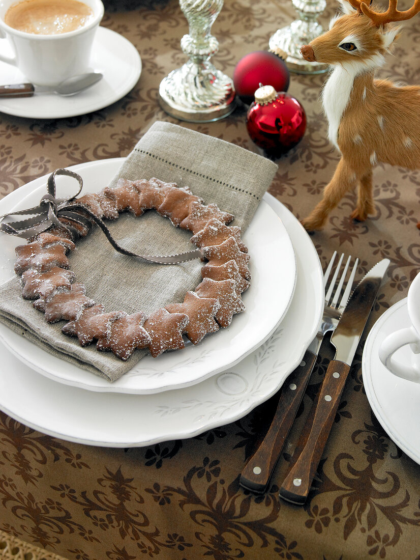 Gingerbread made in shape of star shape on white plate