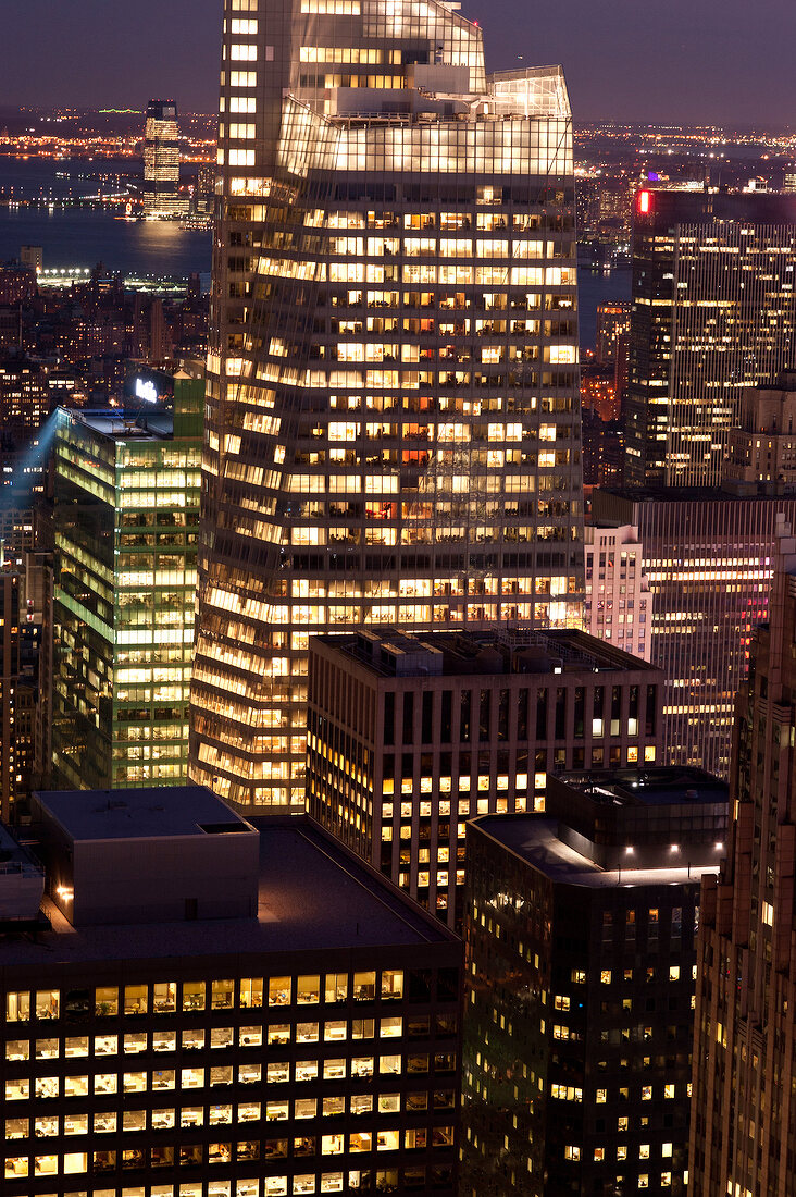 Exterior of Bank of America Tower from Rockefeller Center at night in New York, USA