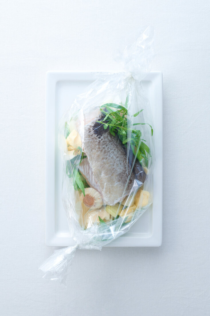 Haddock marinated with tarragon, garlic and butter in sealed transparent film