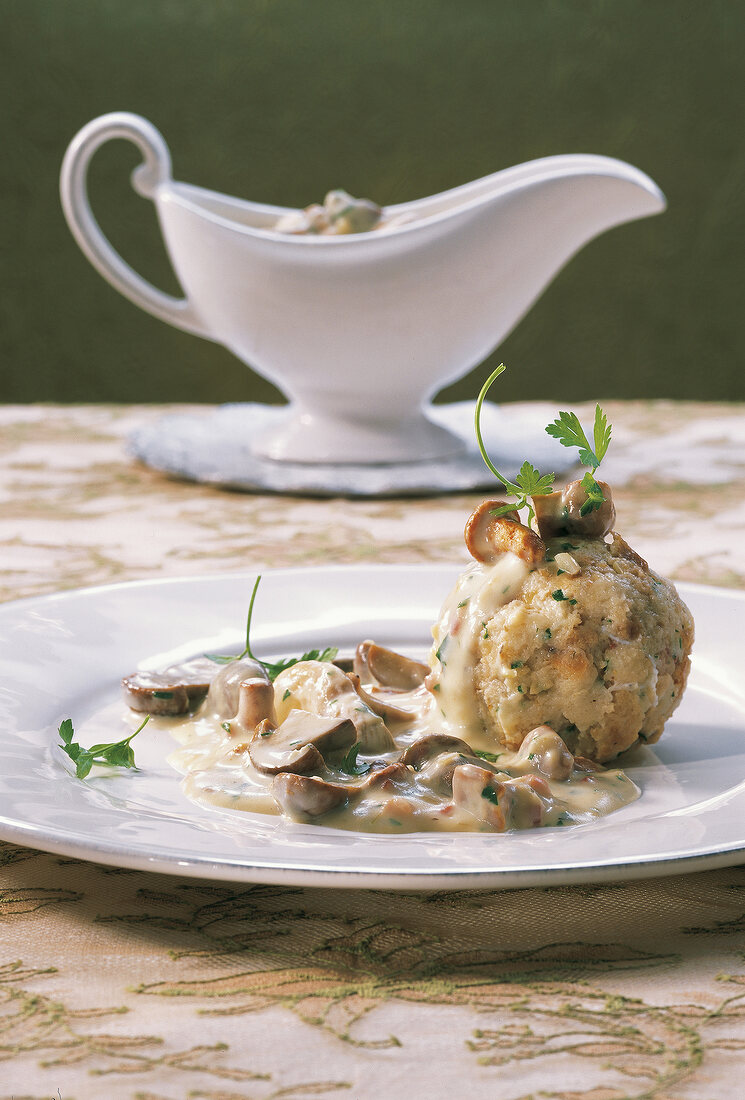 Close-up of mushroom sauce with bread dumplings on plate