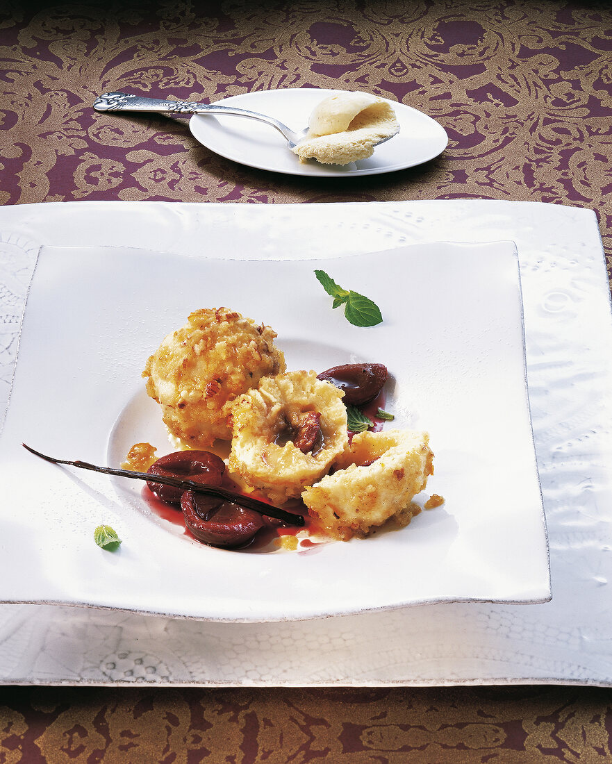 Bowl of plum dumplings in melted butter