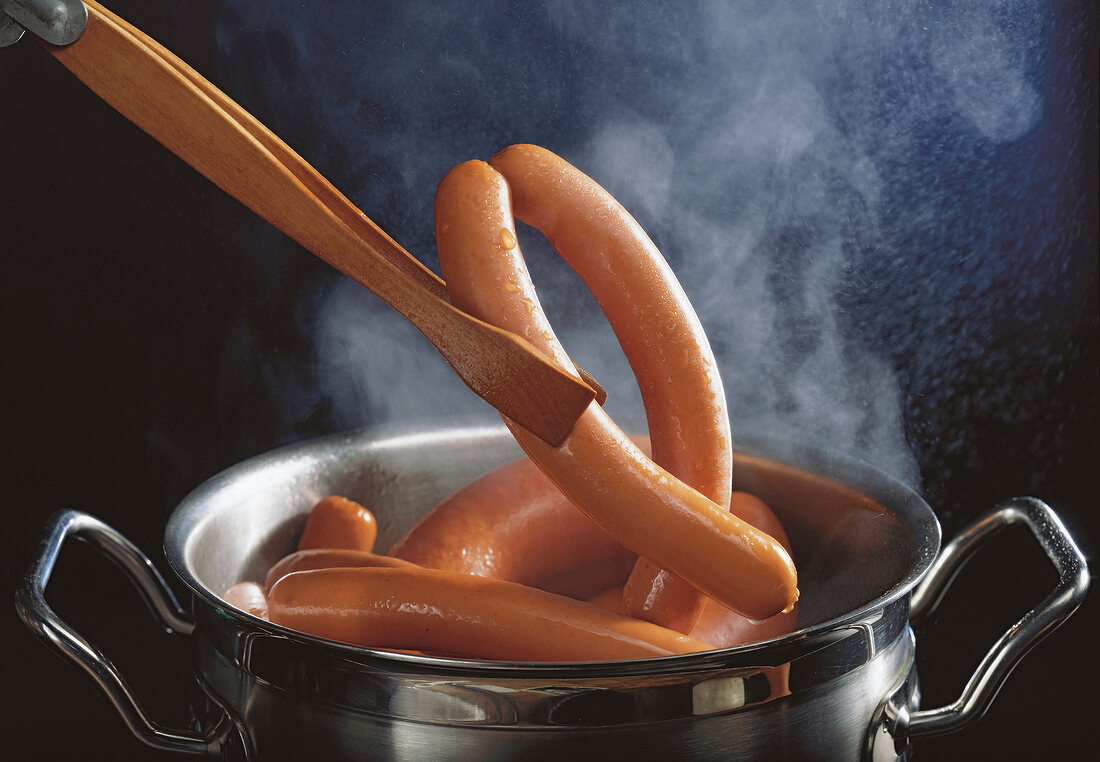 Wiener veal sausage boiling in pot