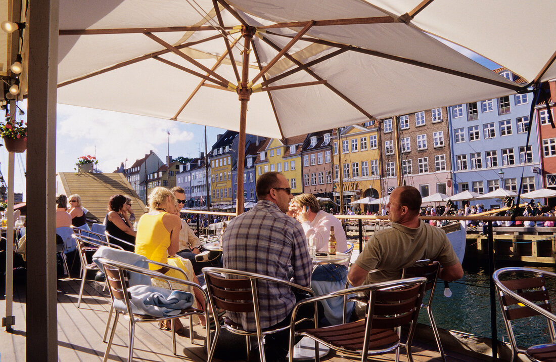 People sitting in ship restaurant, Nyhavn, Copenhagen, Denmark