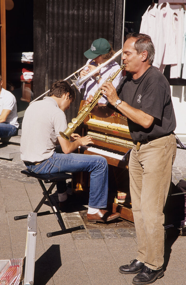 People playing instruments on street in Ostergade in Copenhagenm, Denmark