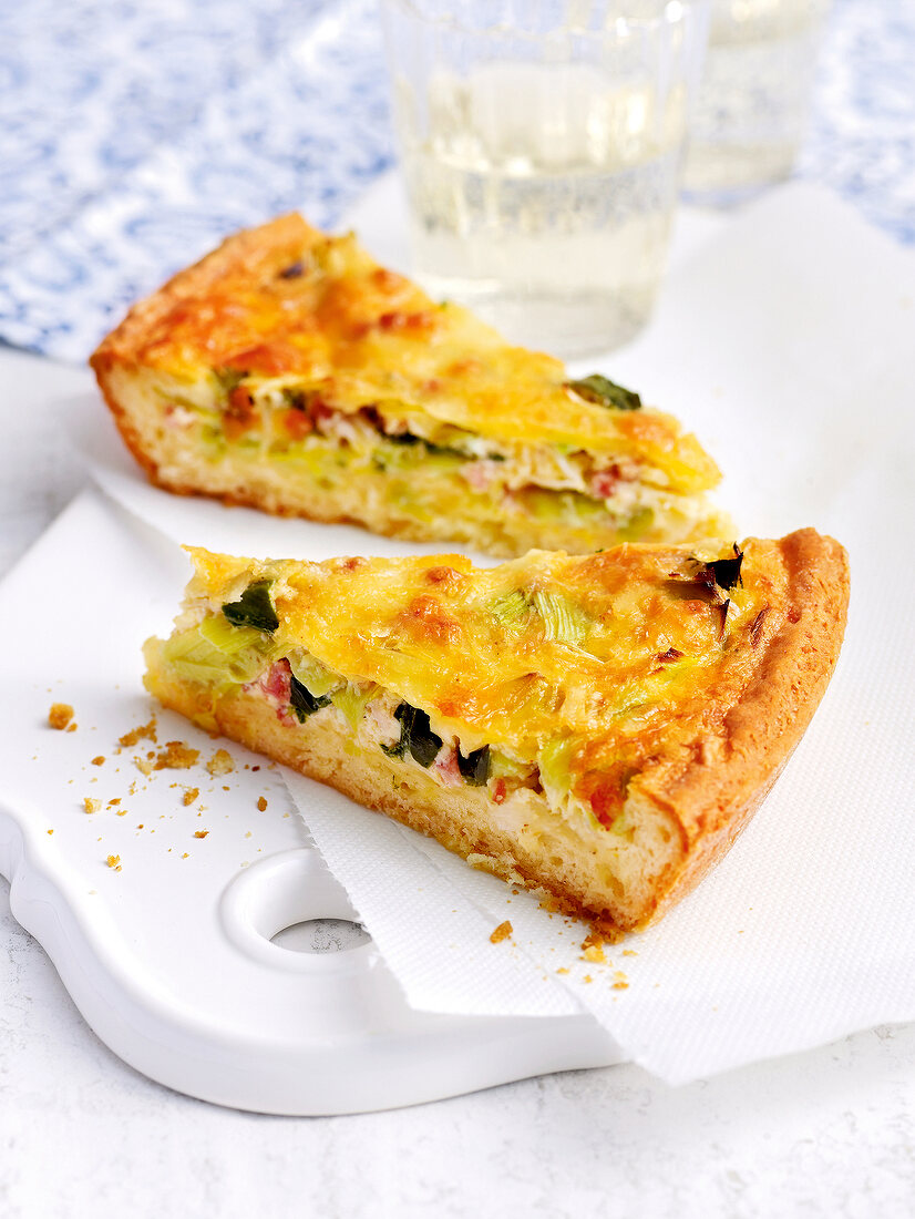 Pieces of quiche lorraine with leek and coriander on plate